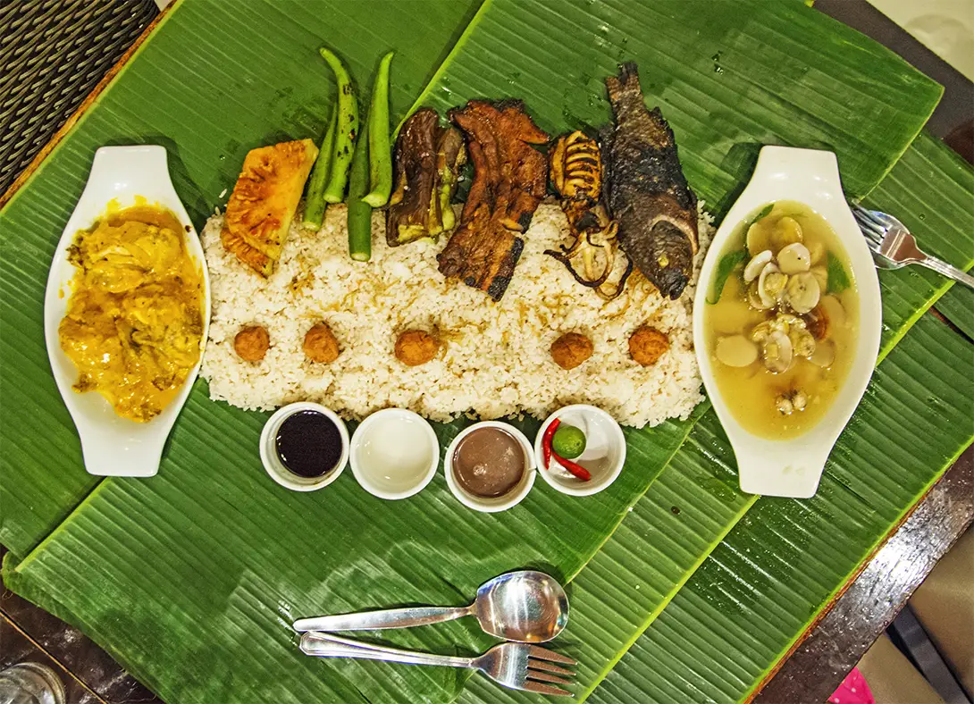 Filipino Meal with soy sauce, vinegar, bagoong, calamansi with pepper as condiments.